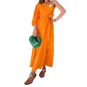 Detailed view of an orange one-shoulder cotton linen midi dress with a belted waist