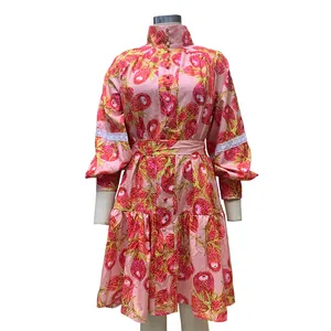 Detailed front view of a pink floral high-neck shirt dress with lace sleeve accents