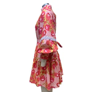 Detailed side view of a pink floral high-collar shirt dress with elegant puff sleeves.