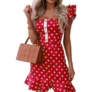 Detailed view of red polka dot mini dress featuring flutter sleeves and gold button accents
