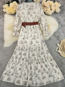 Detail of a vintage floral boho maxi dress with V-neck and a stylish brown belt.