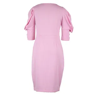 Back view of an elegant pink puff sleeve dress featuring a waist slimming cut and buttons.