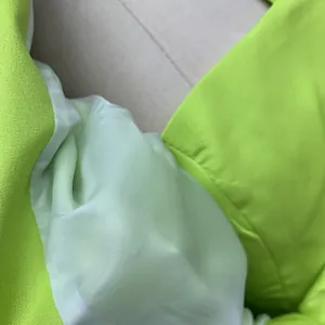 Detailed close-up showing the premium fluorescent green fabric and smooth satin lining texture