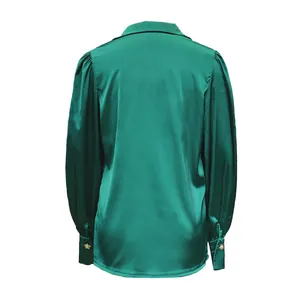 Detailed back view of a green satin shirt featuring elegant lantern sleeves and cuffs.