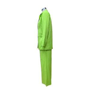 Side profile view of vibrant neon green blazer and matching trousers on a mannequin