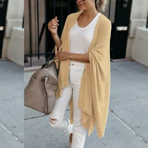 Detail view of women's beige knit cardigan with a loose irregular hem design