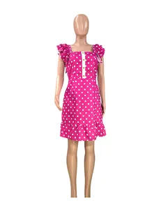 Close-up front view of a vibrant pink polka dot mini dress featuring stylish ruffle sleeves.