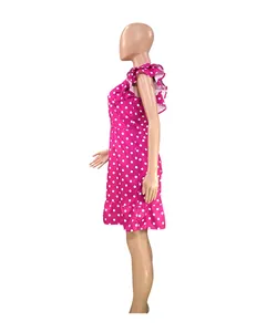 Side view of pink polka dot mini dress featuring flutter sleeves and ruffled hem.