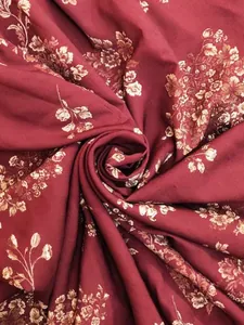 Detailed macro view of vintage bohemian floral print fabric in elegant burgundy red
