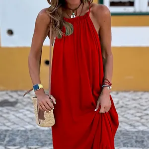 Red halter-neck sleeveless maxi beach dress displayed in a sunny outdoor setting