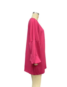 Side view detail of women's casual hot pink oversized long sleeve round neck sweatshirt.