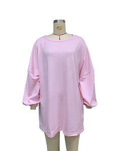 Detailed view of pink oversized long-sleeved sweatshirt with round neck and loose casual fit.
