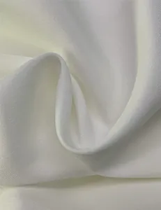 Close-up macro view of the high-quality white evening gown fabric texture