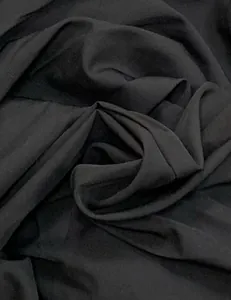 Close-up view of the black fabric texture for the sleeveless halter beach maxi dress