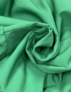 Macro view of green fabric texture for a stylish summer halter beach dress.