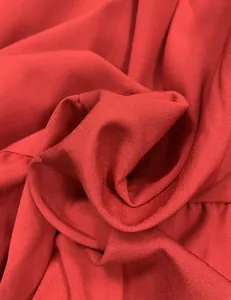 Detailed close-up of the breathable red fabric texture on a long beach dress