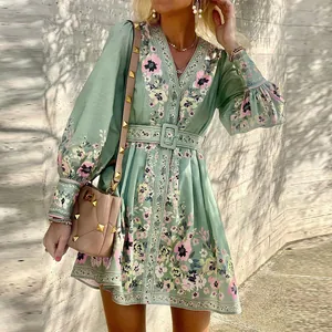 Detailed shot of a sage green floral bohemian V-neck long sleeve dress with belt