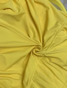 Close-up detail of the bright yellow elastic fabric showing fine stitching and soft texture