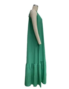 Detailed side profile of an elegant green sleeveless halter maxi dress featuring a ruffled hem