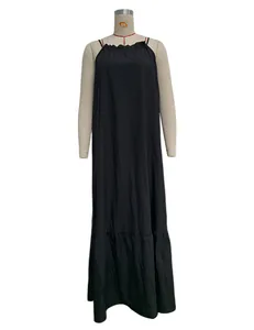 Detailed macro view of a black halter neck sleeveless maxi dress on a studio mannequin