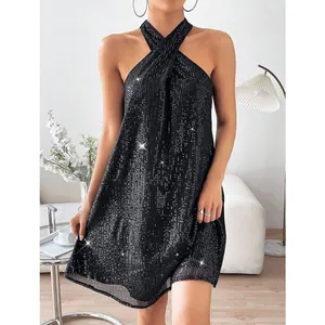 Close-up of the elegant black sequined halter neck mini dress with sparkly light effects