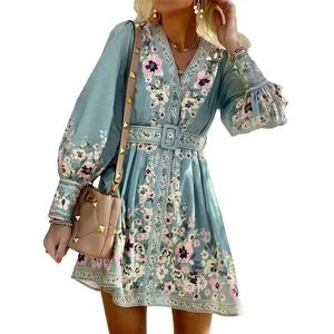 Elegant detail view of a bohemian long sleeve V-neck floral dress in light blue shade