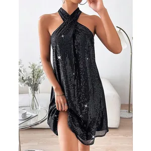 Close-up of sparkling black sequins on a glamorous halter neck cocktail party dress.