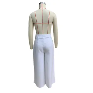 Back view of elegant white high-waisted wide-leg trousers displayed on a dress form