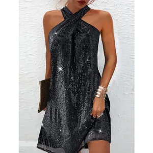 Detail view of black sequin halter dress with cross neckline and shimmering texture.