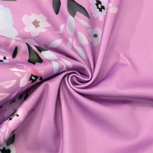 Close-up of soft purple floral printed fabric with a smooth texture for autumn dresses.