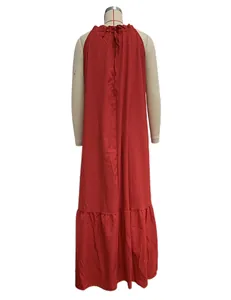 Back view of a red sleeveless halter neck maxi beach dress displayed on a mannequin