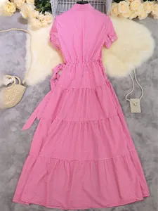 Pink and white striped short sleeve midi dress with waist tie and tiered skirt detail.