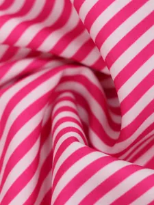 Macro detail of pink and white striped fabric texture for a modern summer dress