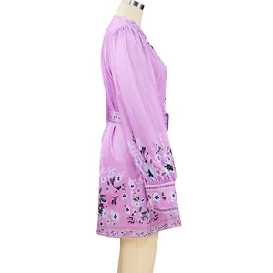 Side view detail of a purple bohemian floral print long-sleeved mini dress with belt