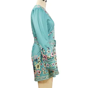 Side profile view of a teal bohemian floral print dress with long sleeves and V-neck.