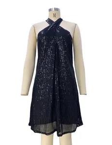Close-up detail of a glamorous black sequined halter neck cocktail dress on a mannequin.