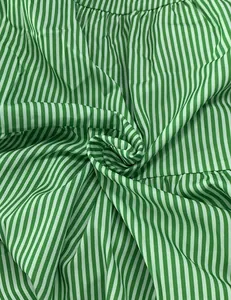 Macro detail showing texture and green white stripes of fashion midi dress fabric