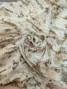 Detailed view of the lightweight bohemian abstract earthy print chiffon fabric texture