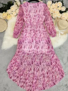 Detail view of a Bohemian V-neck printed maxi dress featuring an irregular ruffled hem