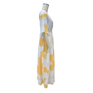 Side view detail of a yellow floral print maxi dress with elastic waist on mannequin