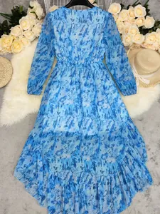 Flat lay view of a bohemian blue floral long-sleeve dress with irregular hem