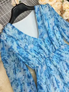 Close-up detail of the Bohemian V-neck dress with blue marble print fabric texture.