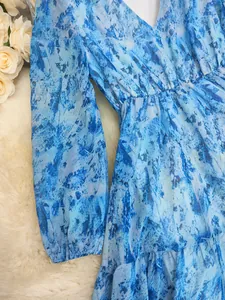 Detailed close-up of blue marble print chiffon fabric on Bohemian V-neck long-sleeve dress
