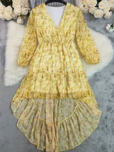 Bohemian yellow floral print V-neck dress featuring a stylish asymmetrical ruffled hem