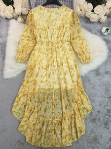 Bohemian yellow floral long sleeve maxi dress with asymmetric high-low ruffled hem.
