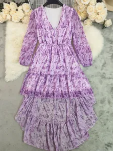Elegant detail of a purple bohemian long sleeve dress with V-neck and tiered hem