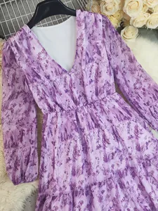 Detail view showing purple marble print and V-neck of bohemian long-sleeved maxi dress