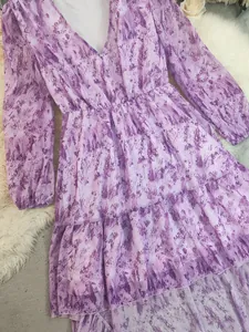 Close-up detail of purple bohemian V-neck printed dress with irregular tiered hem