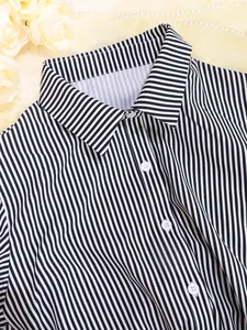 Close-up detail of the classic black and white vertical striped shirt dress collar