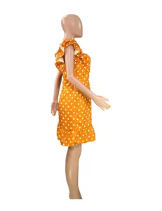 Side view of orange polka dot mini dress with ruffle flutter sleeves and high waist.